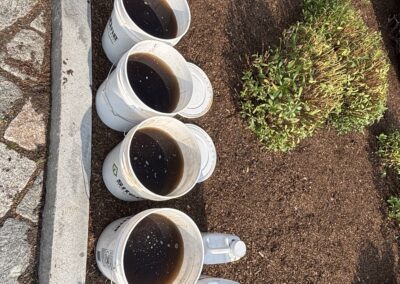 Plant health care treatment supplies beside a shrub bed – Evermore Plant Health Care